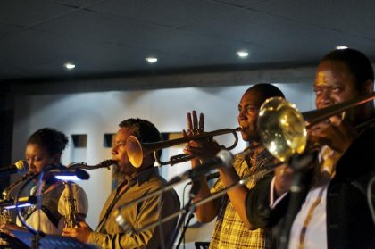 Image of Jazz Jamaica's horn section on stage performing at Hideaway